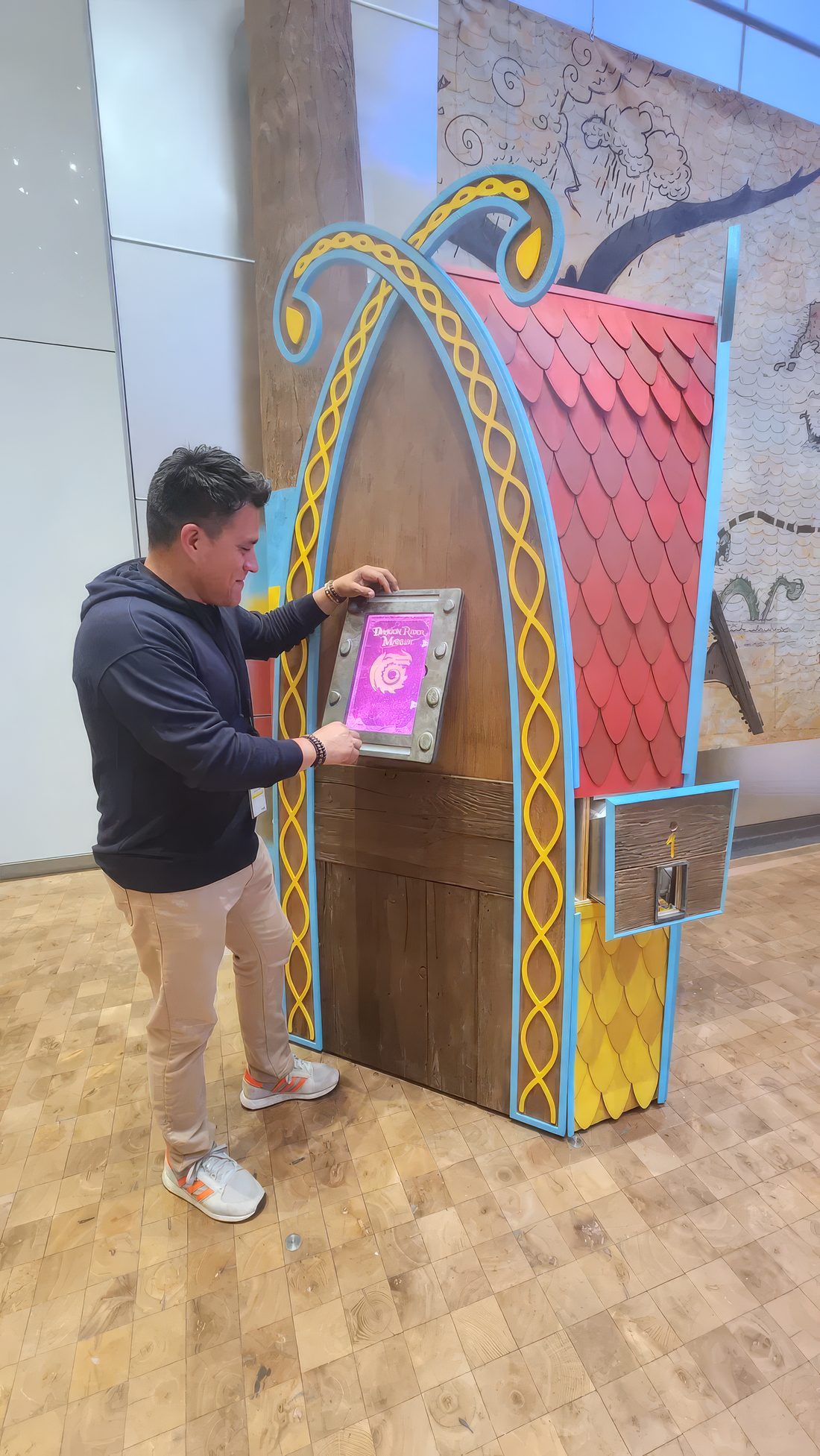 Davidson Ospina testing the touchscreen on a How to Train Your Dragon kiosk